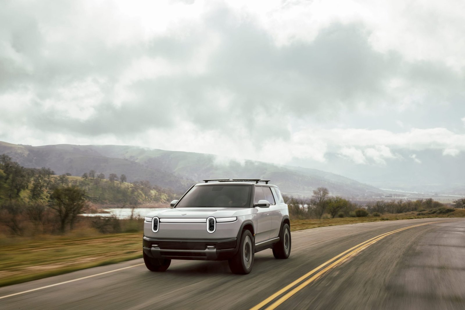 Rivian R2 driving on an open road